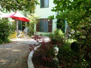 库鲁塔奇尼4号旅馆的一座花园,花园内摆放着红色的遮阳伞,酒店大楼