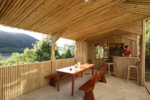 库塔伊西Nature House的木门廊配有木桌和椅子