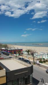 里米尼米兰聂斯酒店的享有海滩、大楼和海滩的景致