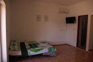 博罗维奇Romantic Apartment In Nature的一间小卧室,配有一张床和电视