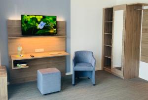 雷马根StadtHotel ARTE的客房设有书桌、椅子和电视。
