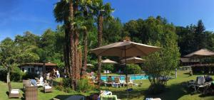 洛索内西厄斯塔公园加尼别墅酒店的一个带椅子和遮阳伞的游泳池的度假酒店