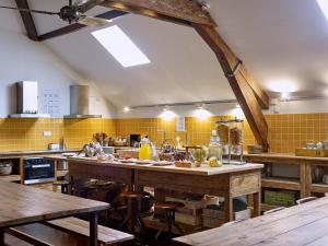 波尔图旅客旅舍的一间大厨房,配有木桌和黄色瓷砖