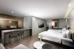 城南市SR Suites Bundang的酒店客房带一张床和一个厨房