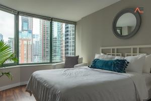 芝加哥ENVITAE 3BR Downtown Luxurious Suite Views & Pool的一间卧室设有一张大床和大窗户