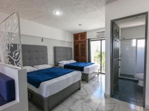 Hotel Pal Cozumel客房内的一张或多张床位