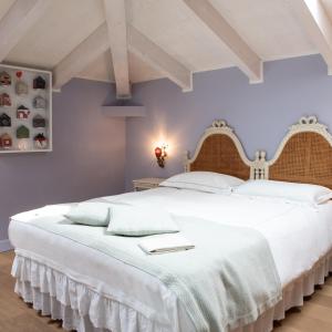 卡拉拉贝尔维多别墅精品酒店的卧室配有白色床单和白色大床