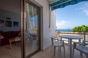 阿罗纳La Niña - Ocean View Apartment的客房设有带桌椅的阳台。