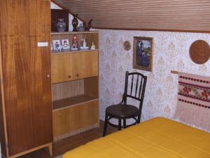 鲍洛通塞迈什Agancs Vendégház的一间卧室配有椅子、床和书架