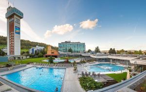 巴德楚尔察赫VitalBoutique Hotel Zurzacherhof的一座带两个游泳池和大楼的度假村
