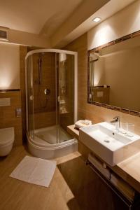 普沃茨克图蒙斯基酒店的带淋浴、盥洗盆和镜子的浴室