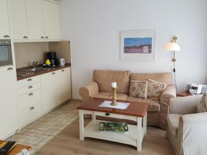 韦斯特兰Sylter-Besserburg-App-16的客厅配有沙发和桌子