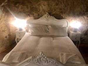 南希尔兹The Grotto的卧室配有带两盏灯的白色床