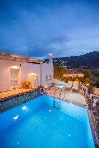 易莫洛林Starlight Luxury Seaside Villa & Suites的夜间带游泳池的别墅