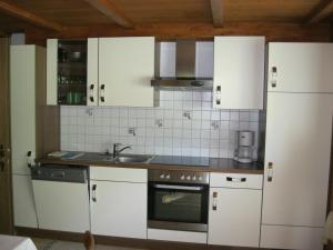 梅劳比查富公寓的厨房配有白色橱柜和水槽