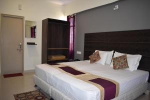 菩提伽耶Hotel Bodh Vilas的一间卧室配有一张大床和大床头板