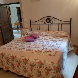 阿尔贝罗贝洛Alberobello Casa Vacanze - Pathos tra i Trulli的一间卧室配有一张带两个枕头的床