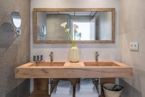 雅弗郎其特拉玛尔酒店的一间带木制水槽和镜子的浴室