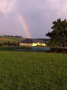 NeufeldenAppartement St. Peter a Wimberg的天上一带房子的彩虹
