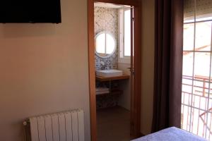 萨瓦德尔Hostal La Romànica的一间带水槽和镜子的浴室