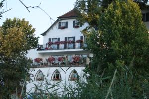 塔贝斯多夫阿尔特斯客尔乡村旅馆的白色的建筑,窗户上装有花盒