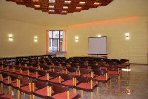 RazgradApart Hotel Central Razgrad的一间空房间,设有讲座大厅,配有椅子和屏幕