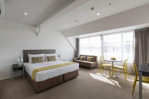 惠灵顿索恩登奎斯特酒店的一间卧室配有一张床、一张沙发和一张桌子