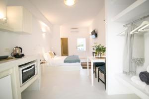 伊亚Apanomeria Boutique Residence的白色客房 - 带床和厨房