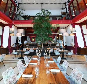 贝莱斯塔Domaine Riberach - Restaurant étoilé - Spa - Piscine naturelle - Vignoble bio的大型用餐室配有长桌和椅子