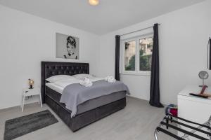 马卡尔斯卡Apartments Morpheus的一间卧室设有一张大床和一个窗户。