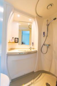 乌普萨拉Hotell Kvarntorget的带淋浴和盥洗盆的白色浴室