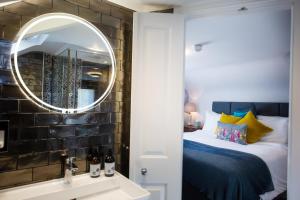灵伍德Moortown Lodge B&B的一间卧室配有床、镜子和水槽