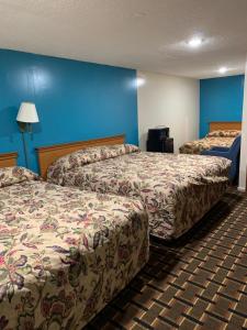 托纳万达蓝色瀑布汽车旅馆的两张位于酒店客房的床,拥有蓝色的墙壁