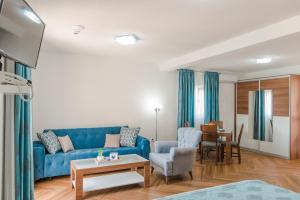 里桑海之星公寓的客厅配有蓝色的沙发和桌子