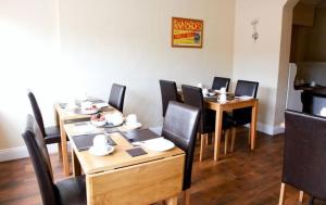 戈尔韦德索塔家庭旅馆的用餐室配有木桌和黑色椅子