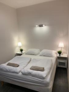 希欧福克银色花园旅馆的一张白色的床,上面有两个枕头