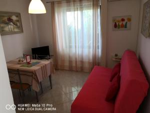 马林斯卡Apartmans Luce e Stella的客厅配有红色的沙发和桌子