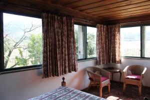 格拉兹杜米尼奥圣维森特魁塔酒店的一间卧室配有一张床、两把椅子和窗户