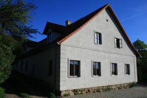 Horní StropniceChalupa Hojna Voda的黑色屋顶的白色房子