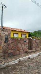 穆库热O Pouso Condomínio的砖墙,有房子的背景