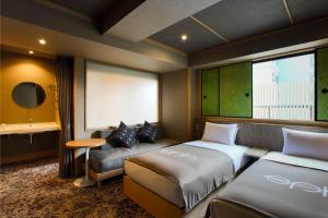 高山eph TAKAYAMA的酒店客房,设有两张床和一张沙发