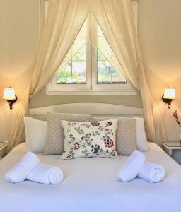 阿齐欧斯·贡多斯Sebastian's - Agios Gordios Beach的一间卧室配有带两个枕头的床和窗户