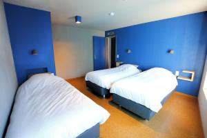斯塔沃洛ô ChÔmière的蓝色墙壁客房的两张床