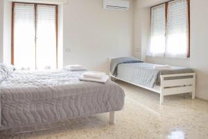MassignanoB&B Alba sul Mare的一间卧室设有两张床和两个窗户。