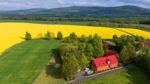 WolimierzChata na Borowinowej的享有农场的空中景色,拥有红色的房子和田野