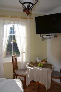 派尔努Papli Villade Apartment的客房设有一张桌子、两把椅子和一个窗户。