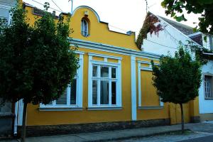 凯奇凯梅特VINTAGE in Old Town的街上的黄色房子,有白色窗户