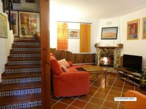 AragosaSpa y Casa Rural Rio Dulce的客厅设有红色椅子和壁炉