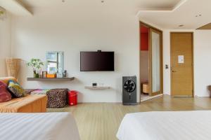 马公海之径民宿的客厅配有沙发和墙上的电视