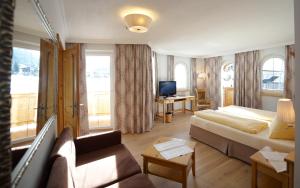 弗拉绍丽莎酒店的酒店客房配有床、沙发和电视。